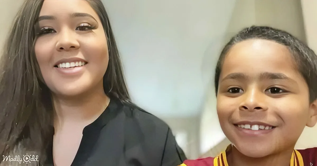 A smiling woman with long dark hair and a young boy in a red and yellow shirt are both smiling.