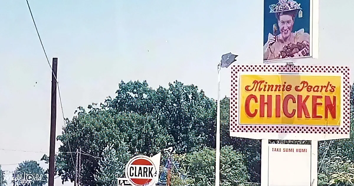A billboard advertises Minnie Pearl Chicken with a large image of Minnie Pearl above it.