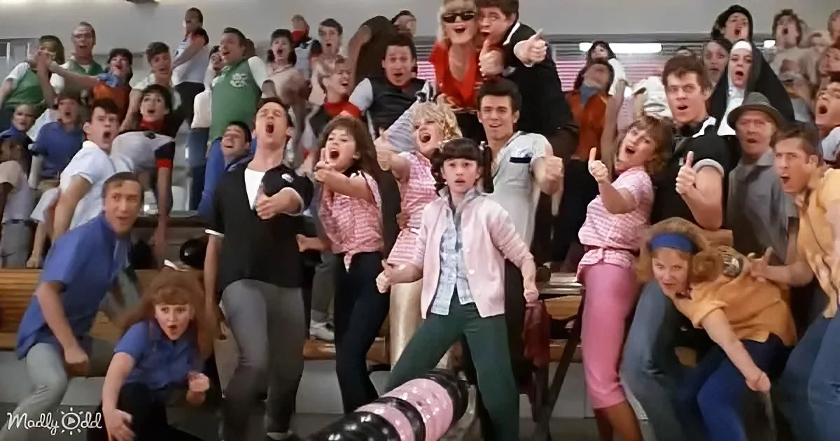 A group of excited teenagers in a gymnasium, cheering and celebrating together.