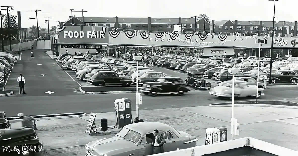 A bustling Food Fair store with crowded parking lot and vintage cars, 1950s style.