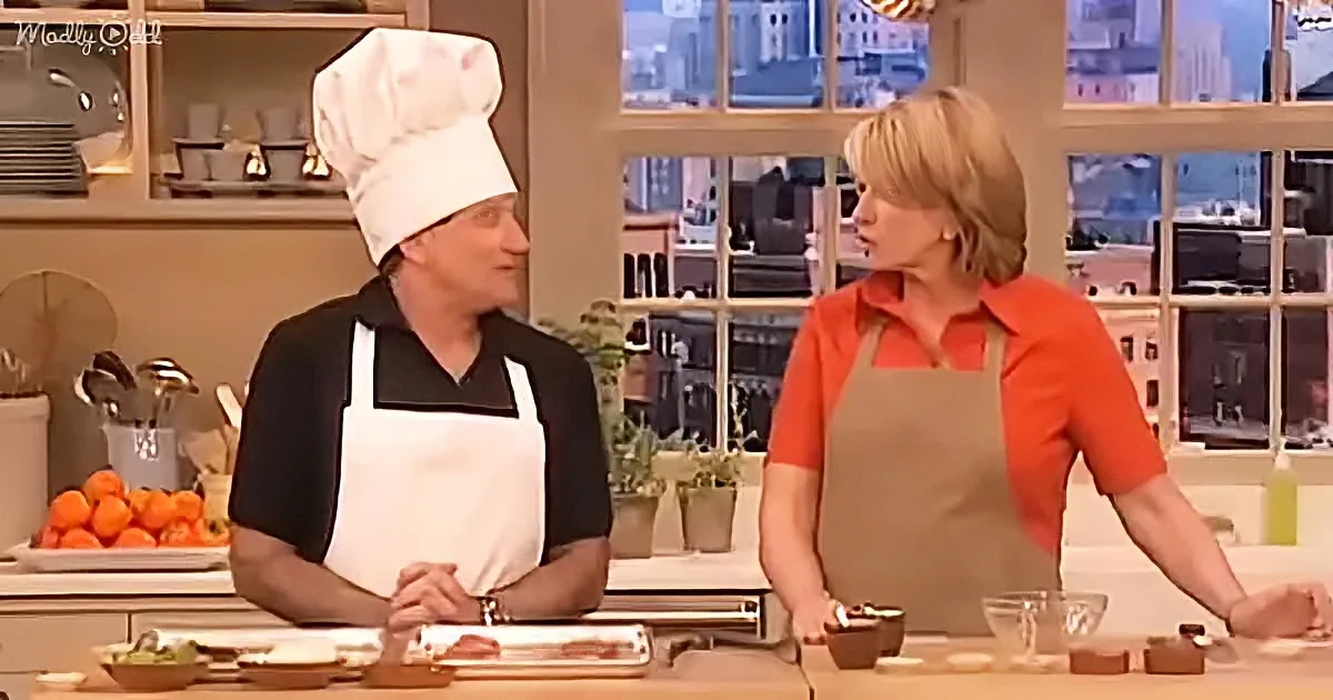 A man in a chef's hat and apron stands next to a woman in an apron in a kitchen setting.