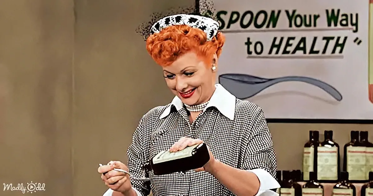 A woman in a checkered shirt and hat holds a spoon and a jar, smiling near a sign that reads "SPOON Your Way to HEALTH."