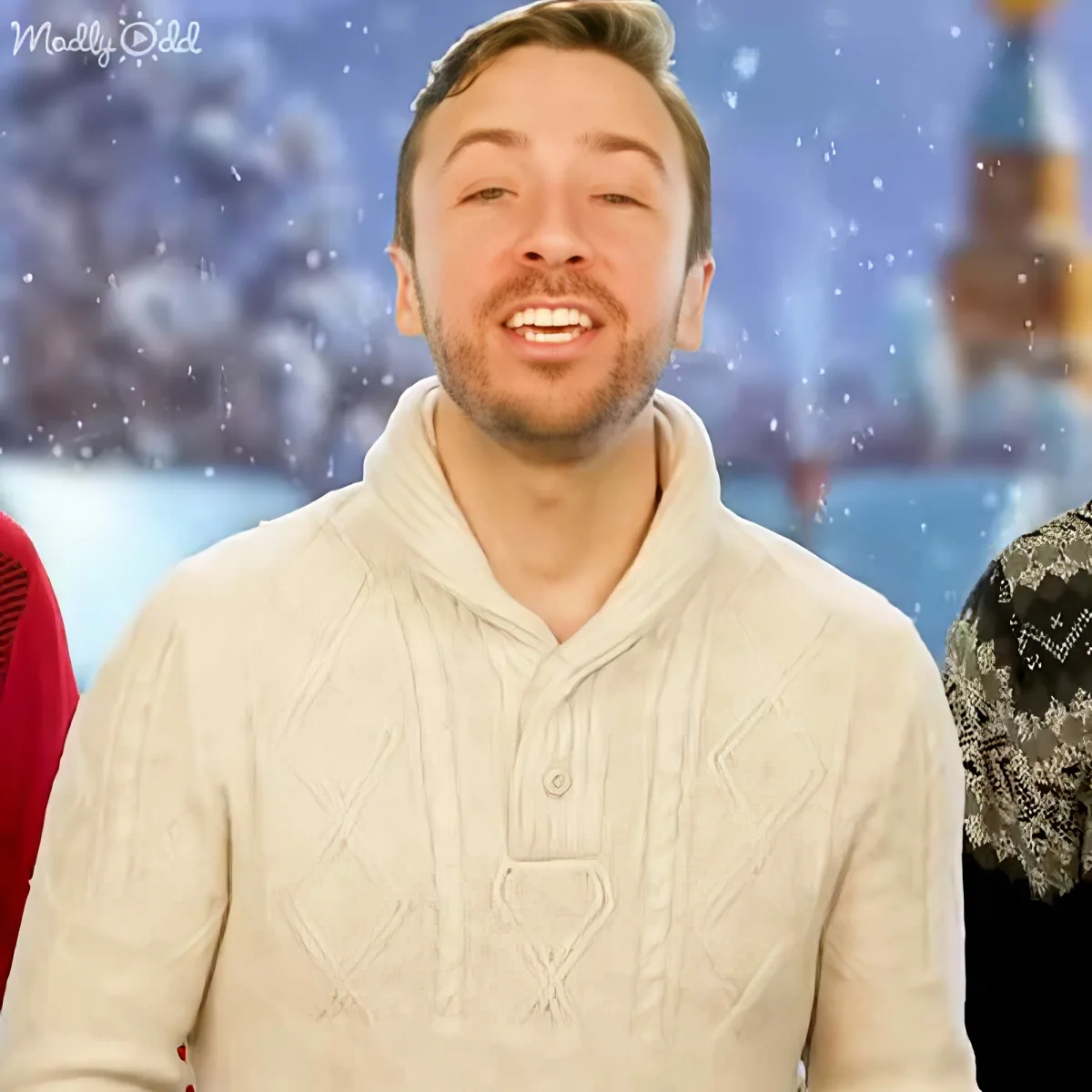 A man in a white sweater smiles in front of a snowy background with a "Madly Odd" logo.
