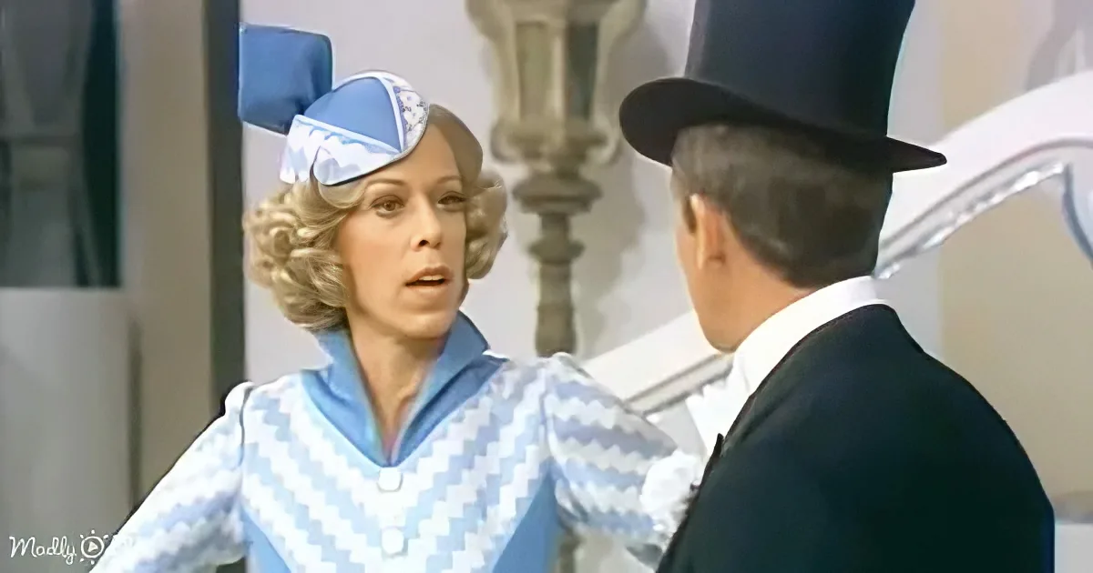A woman in a blue and white uniform with a bow on her head is speaking to a man in a black top hat and suit.