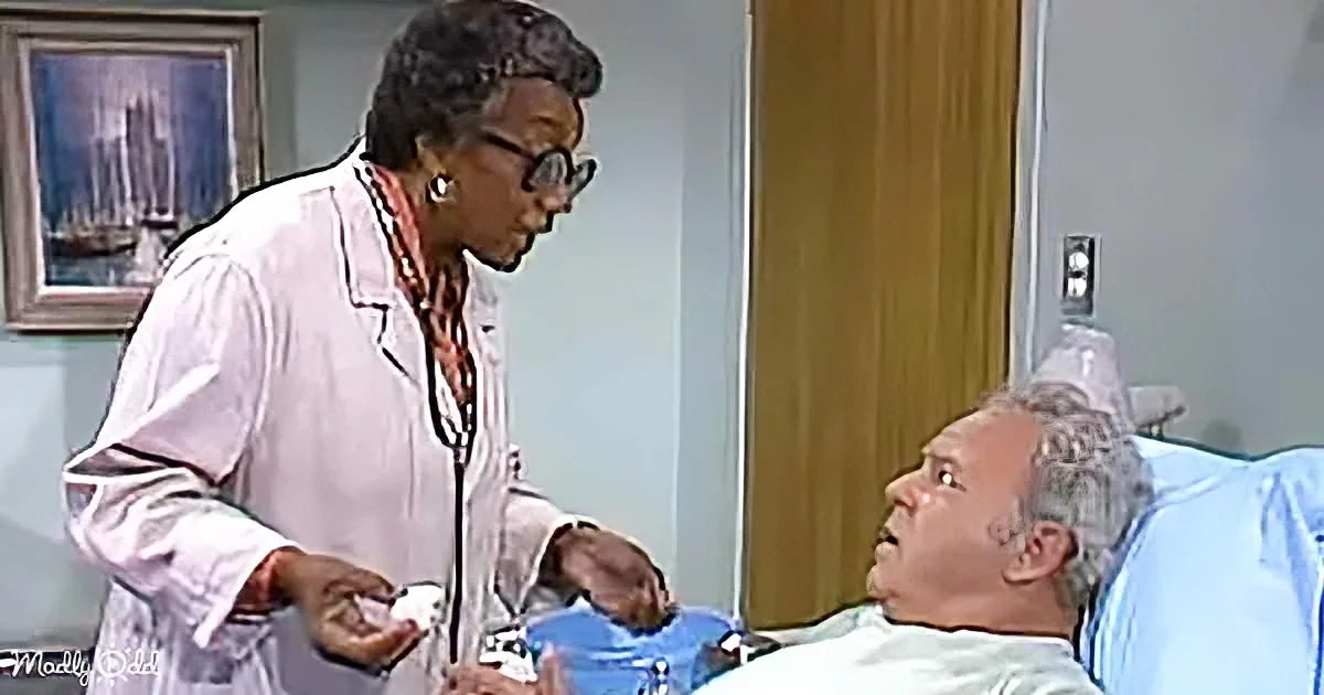 A doctor in a white coat stands beside a patient in a hospital bed, holding a stethoscope and a small object.
