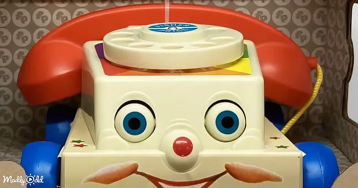 A vintage Fisher-Price telephone toy with a smiling face and colorful details.