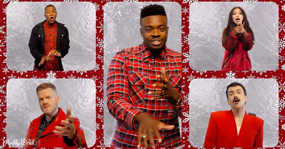A man in a red plaid shirt gestures while surrounded by four other individuals in festive attire against a...
