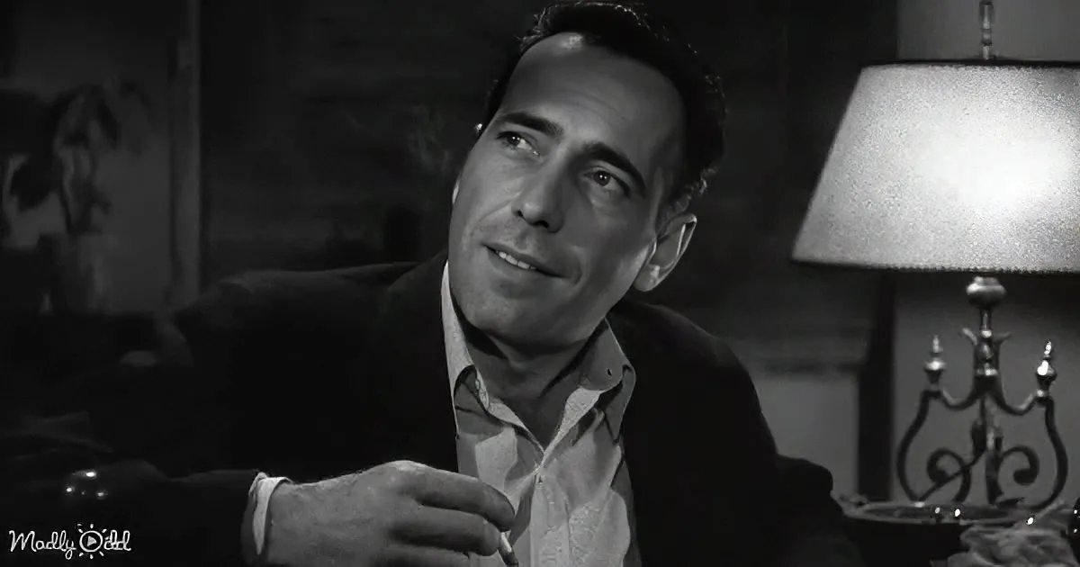 A man in a suit sits contemplatively, holding a cigarette, with a lamp and ornate furniture in the background.