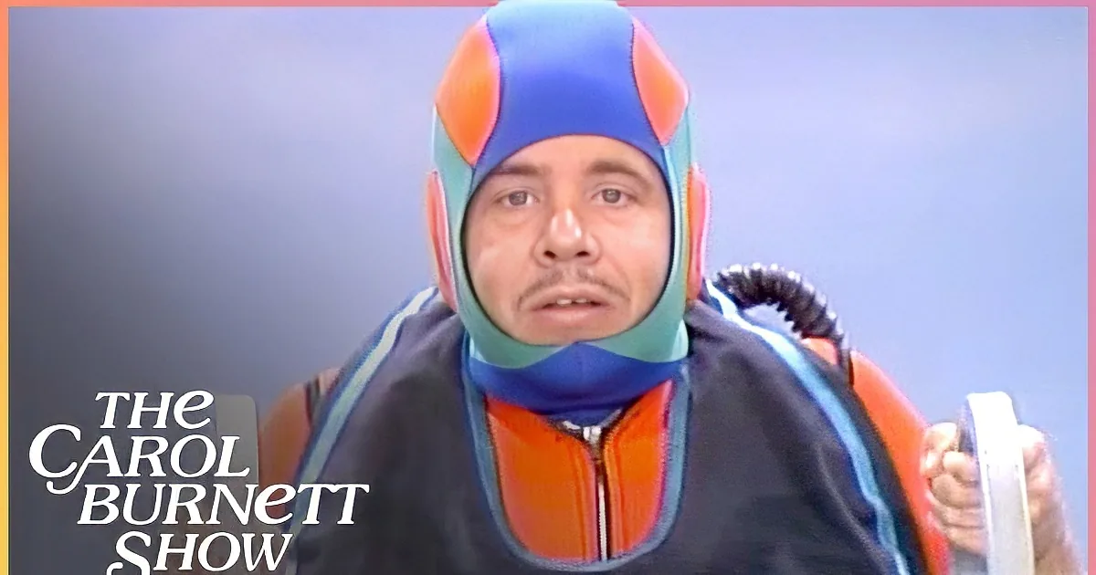 A person in a colorful, futuristic outfit holds two handles, appearing ready for an activity.