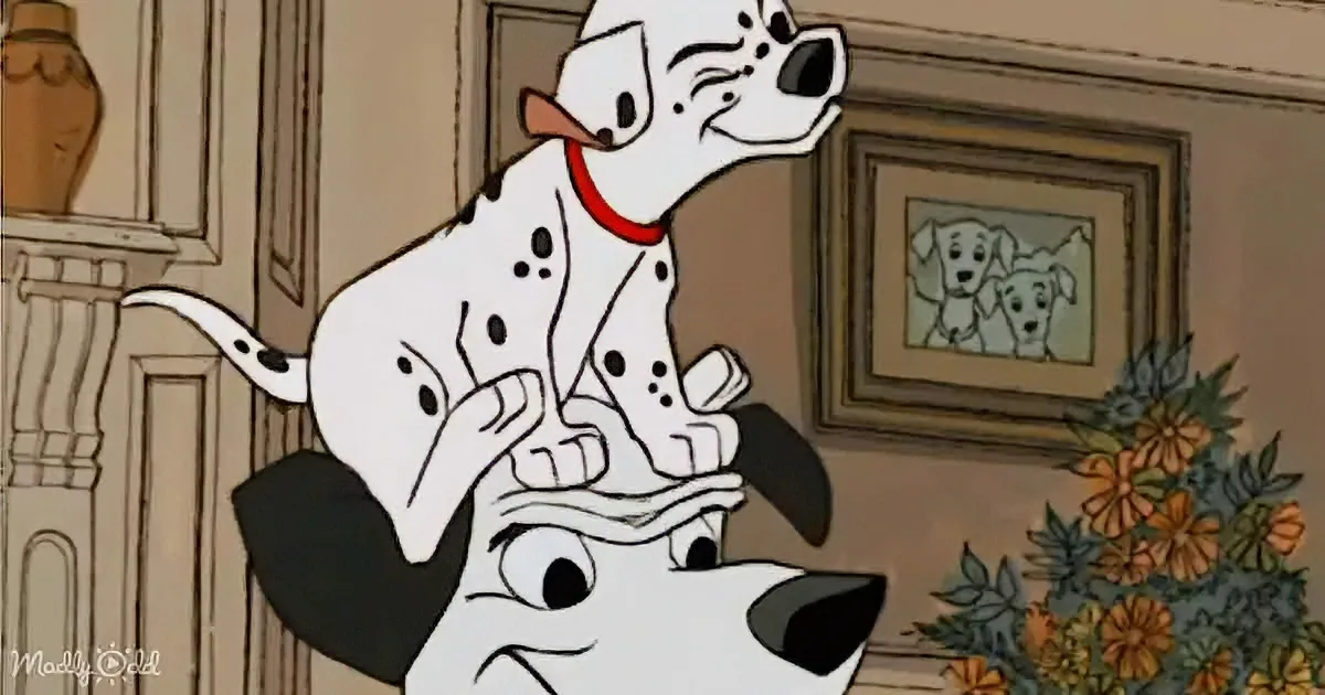 A Dalmatian dog, wearing a red collar, is playfully interacting with another dog in a cozy indoor setting.