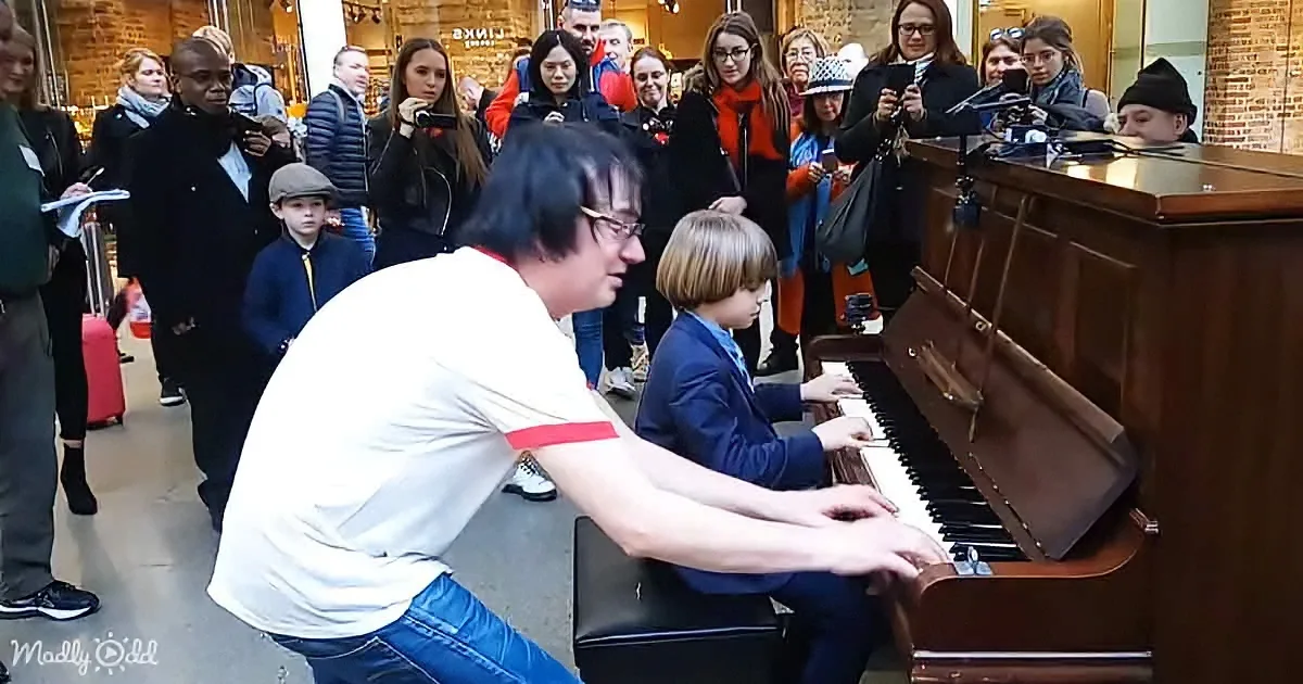 Terry Miles and an little boy playing a public piano