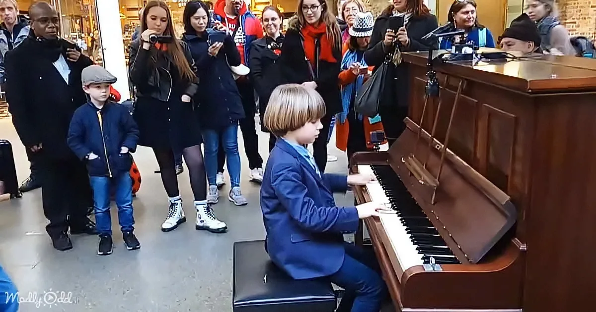 Terry Miles and an little boy playing a public piano