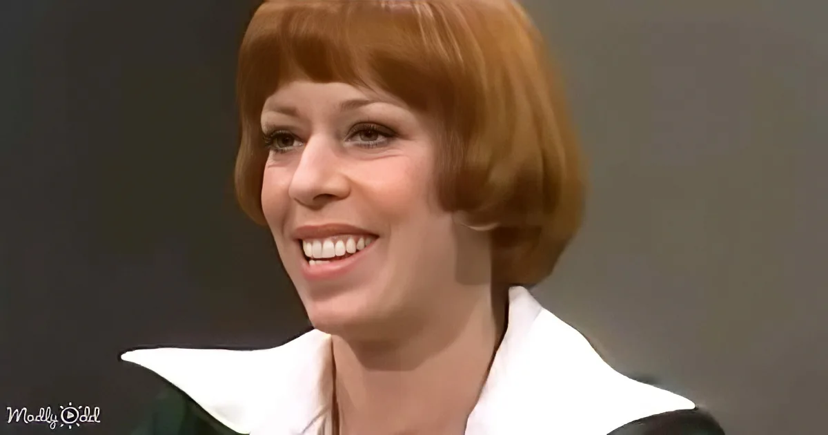 A smiling woman with short red hair, wearing a white and green outfit, is the main subject of the image.