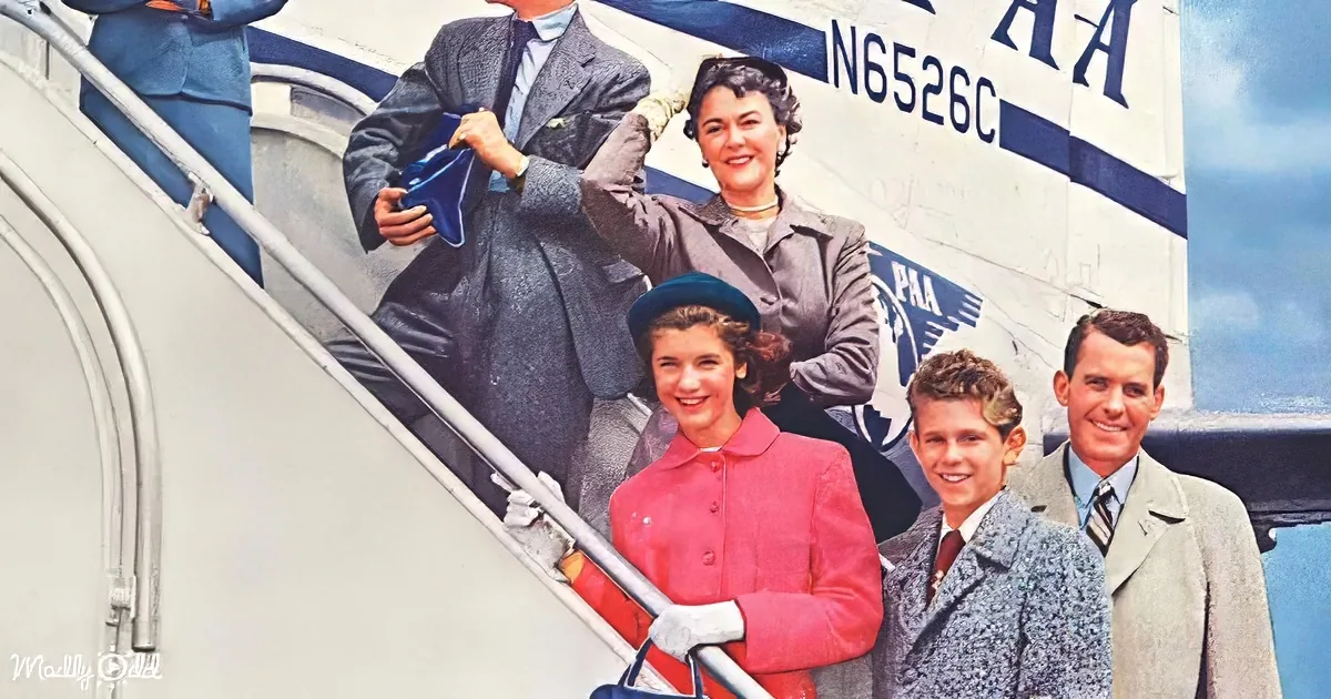 A family descends from a Pan Am airplane, dressed in 1950s attire, smiling and holding luggage.