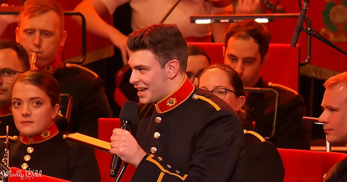 A man in a military uniform speaks into a microphone, surrounded by others in similar attire.