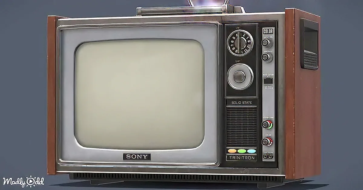 An old Sony Trinitron television with a wooden frame and control panel is displayed against a dark background.