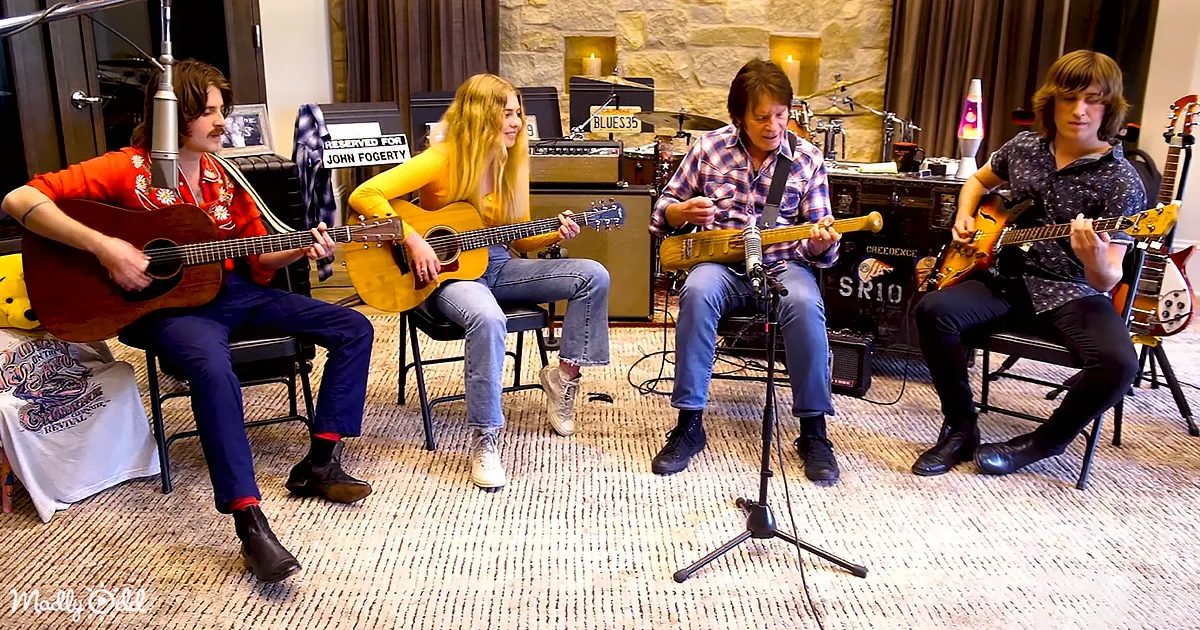 Four musicians play guitars in a cozy studio setting with vintage instruments and warm lighting.