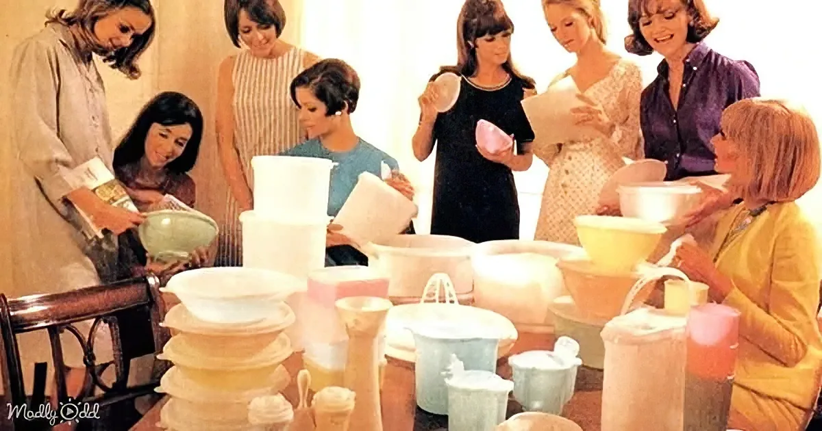 Women gather around a table filled with various kitchenware, seemingly engaged in a cooking or baking activity.