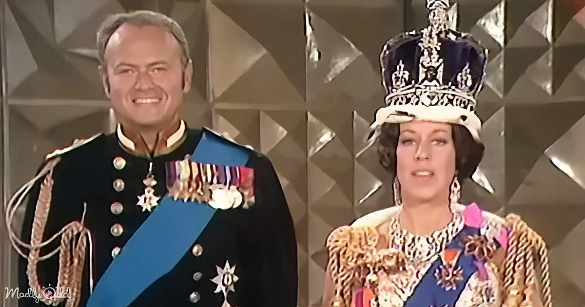 A man in a military uniform and a woman in a crown and ornate outfit stand side by side.