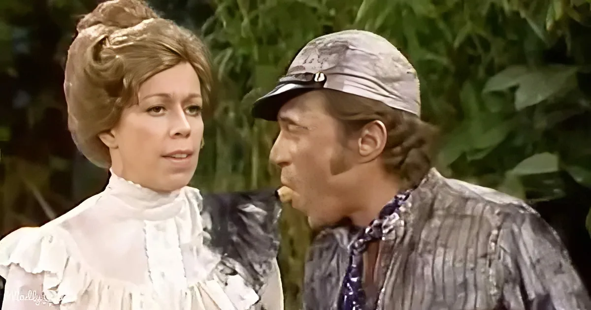A man in a hat and striped shirt is eating something, while a woman in a white dress looks on.