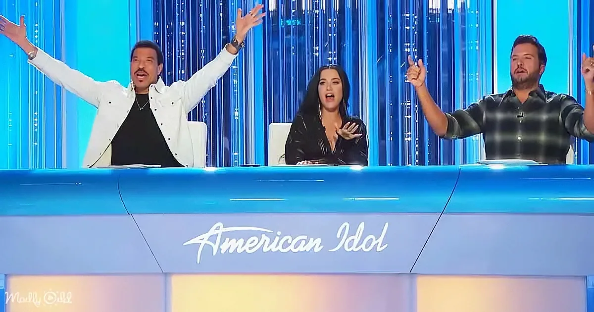 Three judges on "American Idol" set, one with arms raised, another clapping, third with hand up, all reacting...