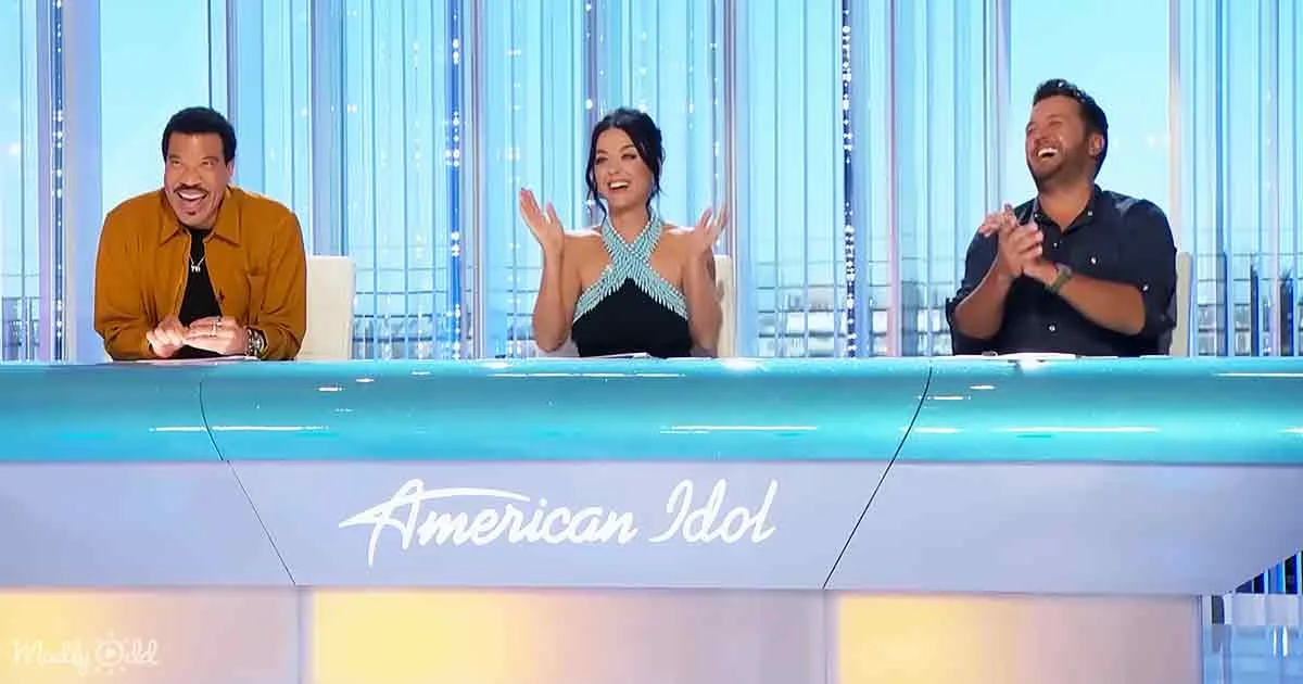 Three judges on "American Idol" set, smiling and clapping, with the show's logo visible.