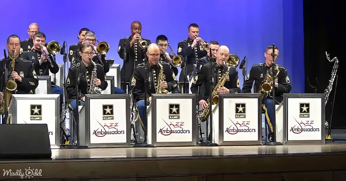 A U.S. Army Jazz Ambassadors band performs on stage with saxophones and other instruments.