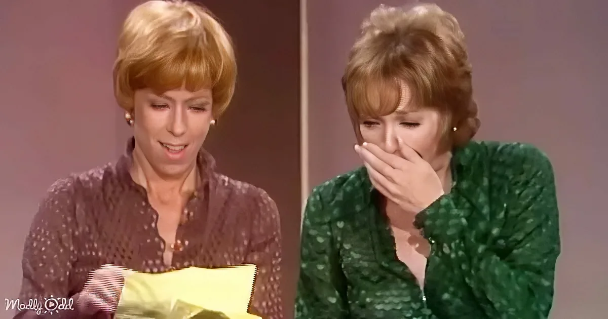 Two women, one holding a yellow envelope and the other covering her mouth, both appearing surprised or emotional.