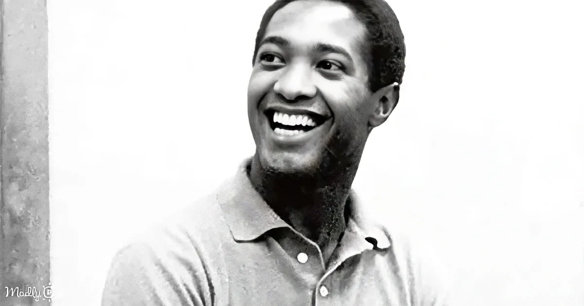 A smiling man in a collared shirt, black and white photo.