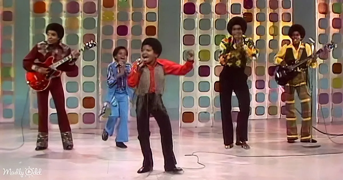 A lively performance by a band in colorful outfits, with a vibrant background and dynamic stage presence.