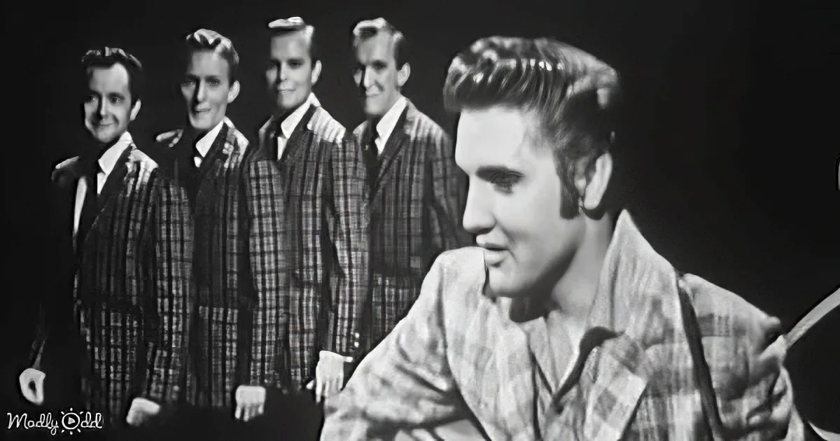 Elvis Presley in a plaid shirt, playing guitar, with four backup singers in matching plaid suits behind him.
