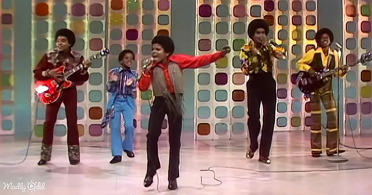 A lively performance with a group of musicians and dancers on a colorful stage.
