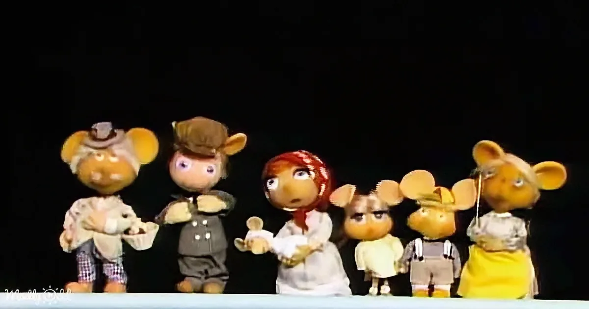 A group of six puppet mice in various outfits stand together, seemingly in a line.