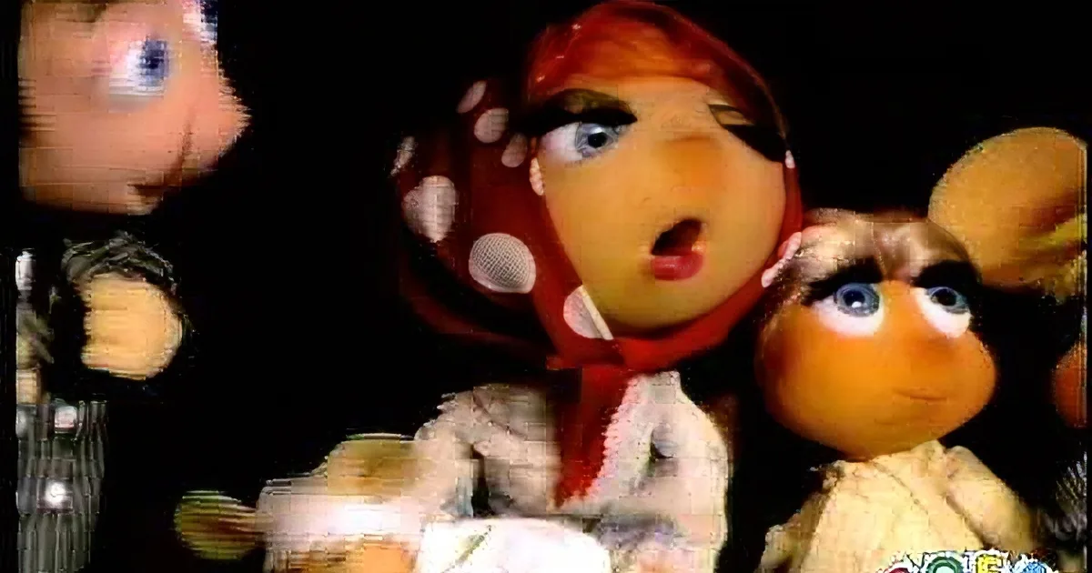 A surreal, distorted image of a doll with exaggerated features and a red polka-dot hat.