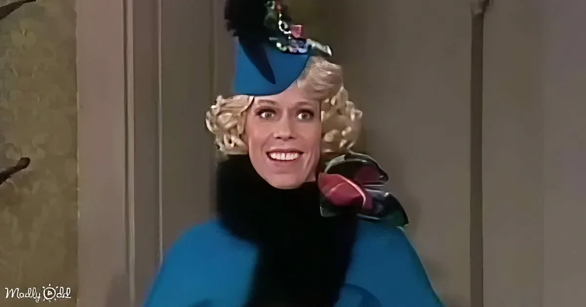 A woman in a blue outfit and hat with a surprised expression, holding a red object.