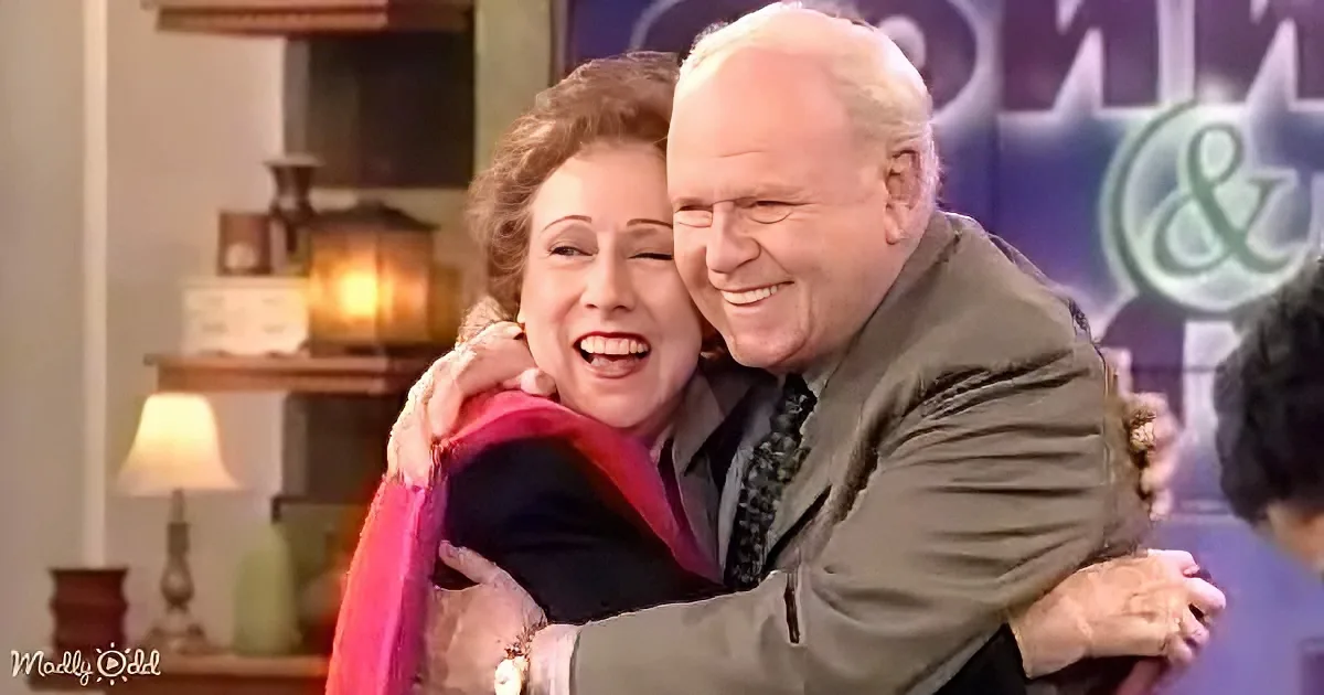 An older couple embraces warmly, smiling and laughing together in a cozy setting.