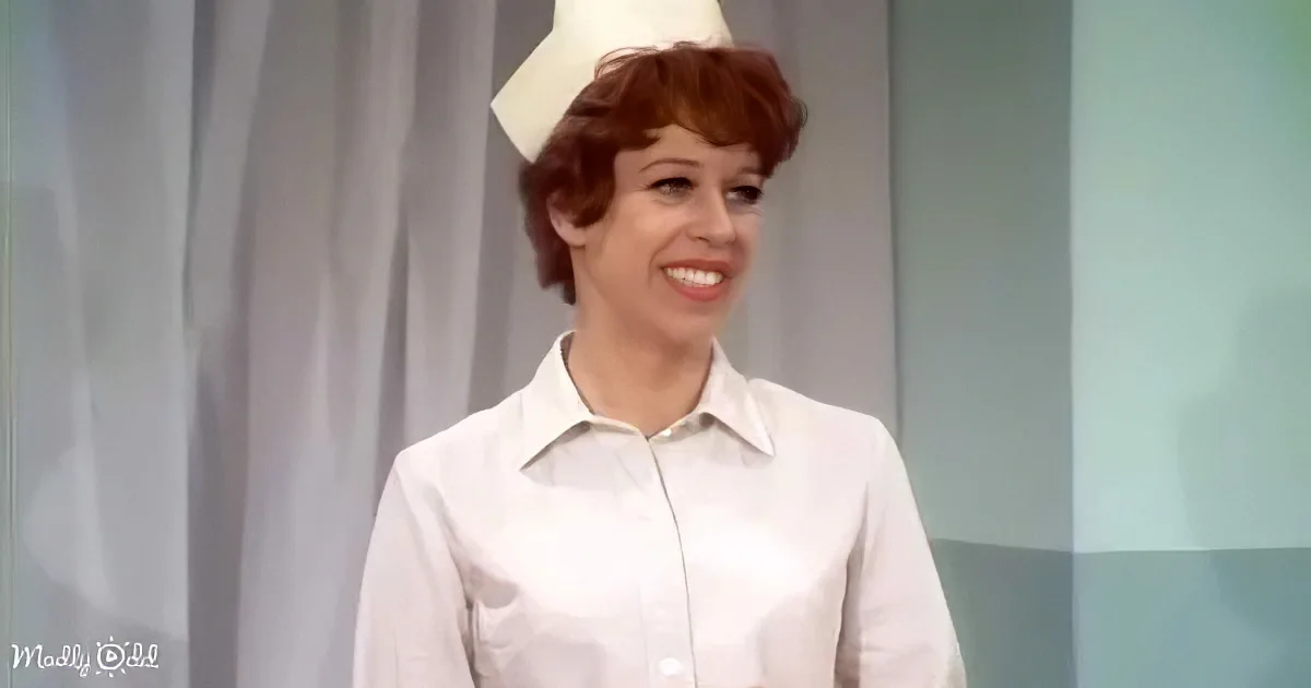 A woman in a white nurse's uniform and cap smiles, standing against a light background.