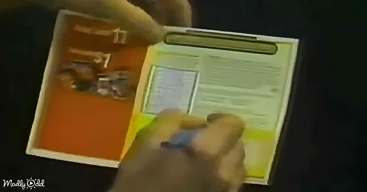 A hand holds a clipboard with a form, while another hand points at the form.