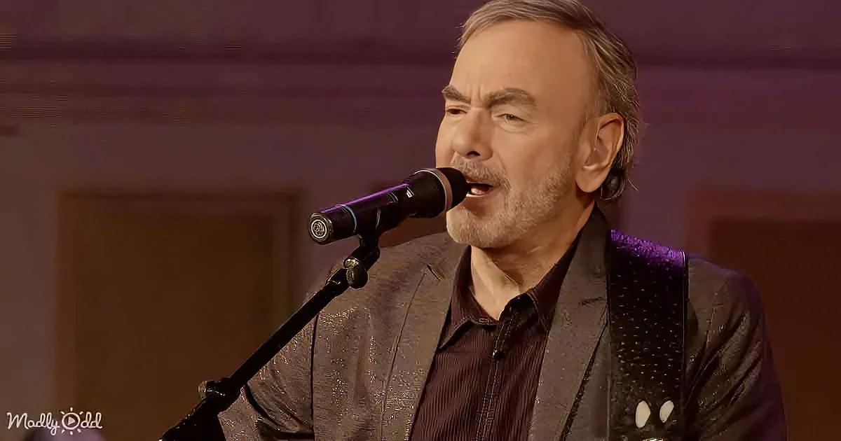 A man in a suit sings into a microphone, wearing a dark shirt and a patterned vest.