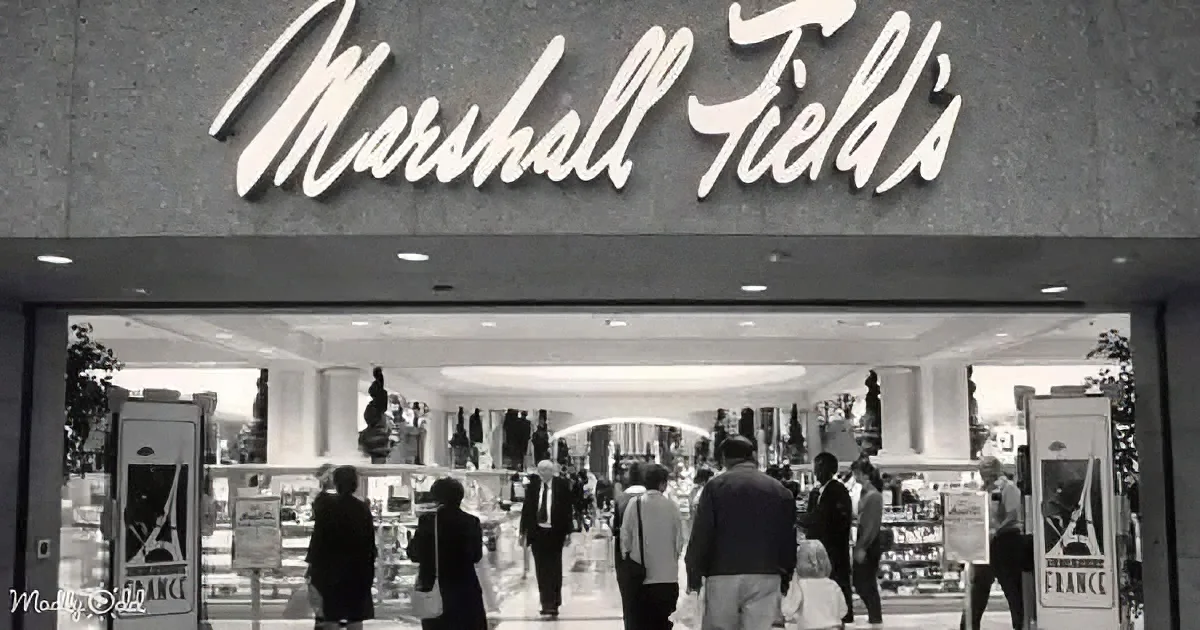 Marshall Field's store entrance with people inside, large sign above, black and white photo.