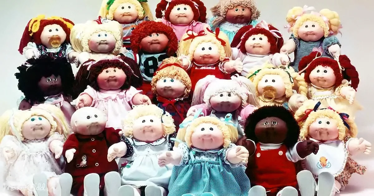 A group of Cabbage Patch Kids dolls with various hairstyles and outfits are posed together.