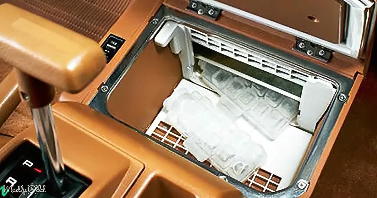 A vintage car's center console features a built-in dishwasher, a unique and quirky design element.