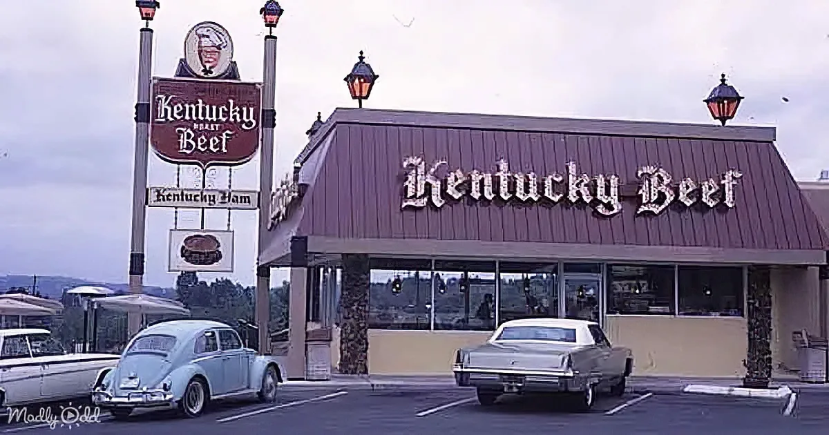 Kentucky Beef restaurant sign with vintage cars parked in front.