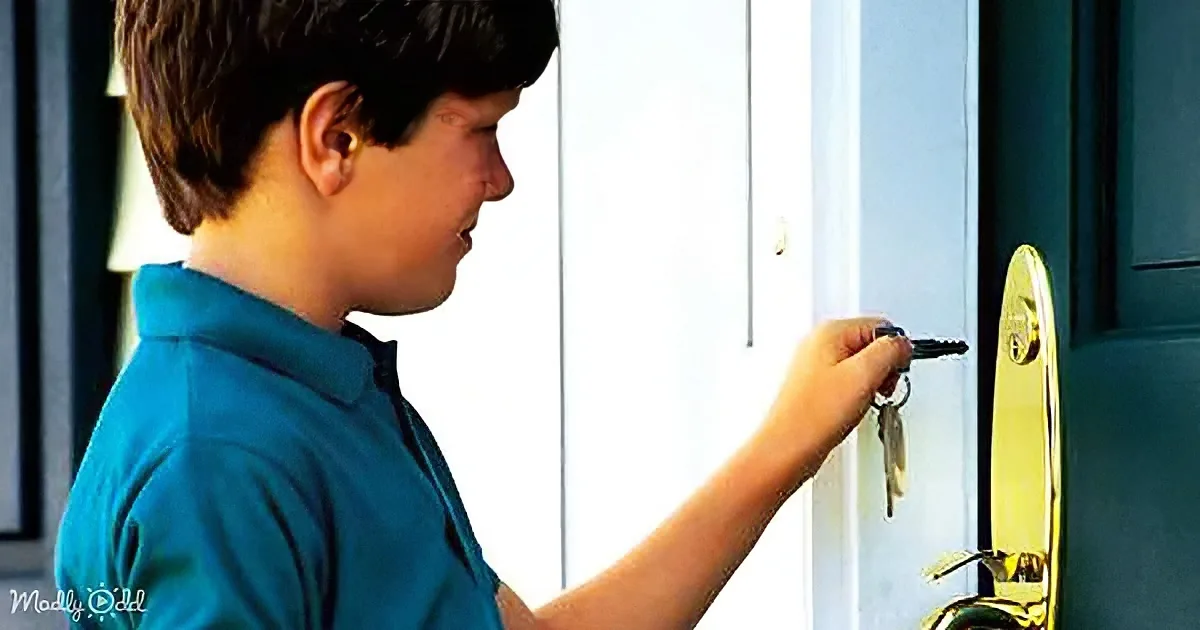 A boy in a blue shirt is holding a key, about to unlock a door.