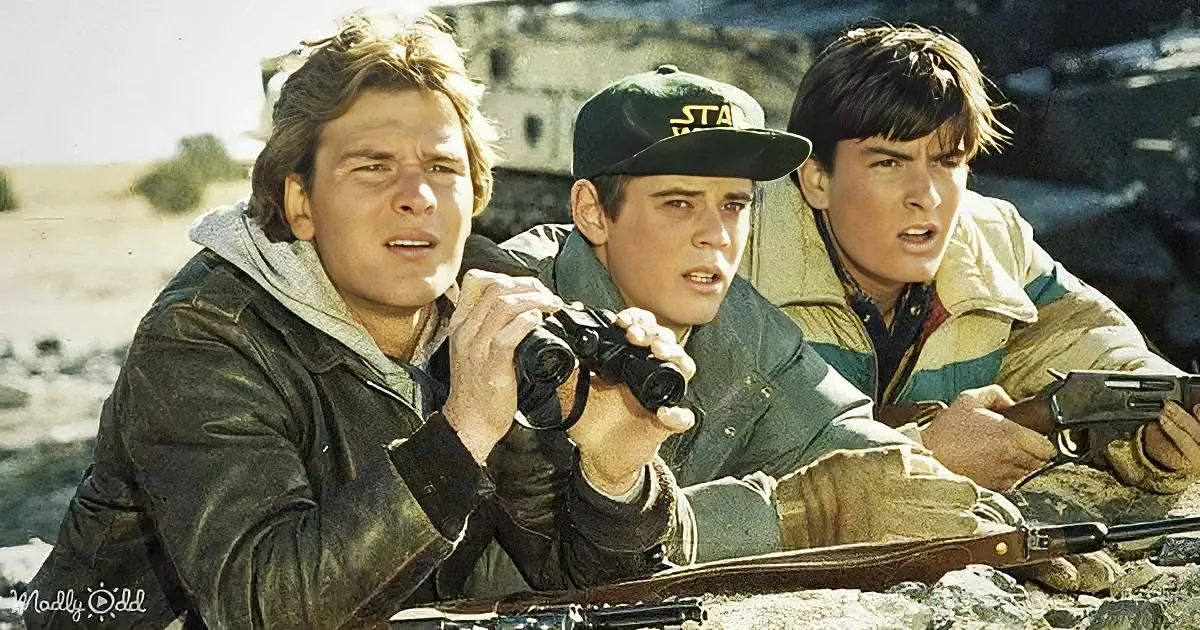 Three men in military gear, one holding binoculars, appear tense in a desert setting.