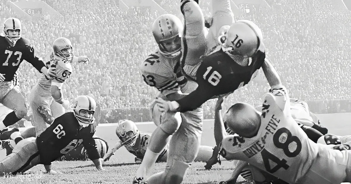 A football player in a black jersey is being tackled by a player in a white jersey during a game.