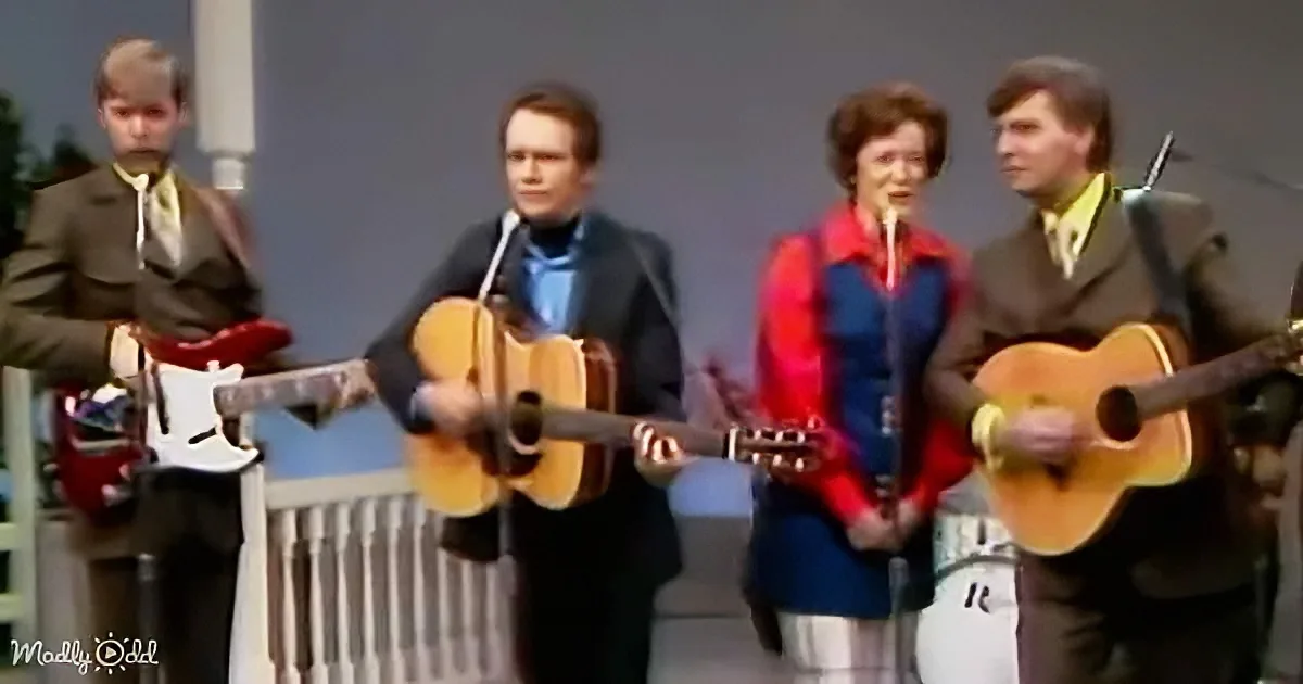 A group of musicians in vintage attire performs with guitars and a flute, creating a lively musical scene.