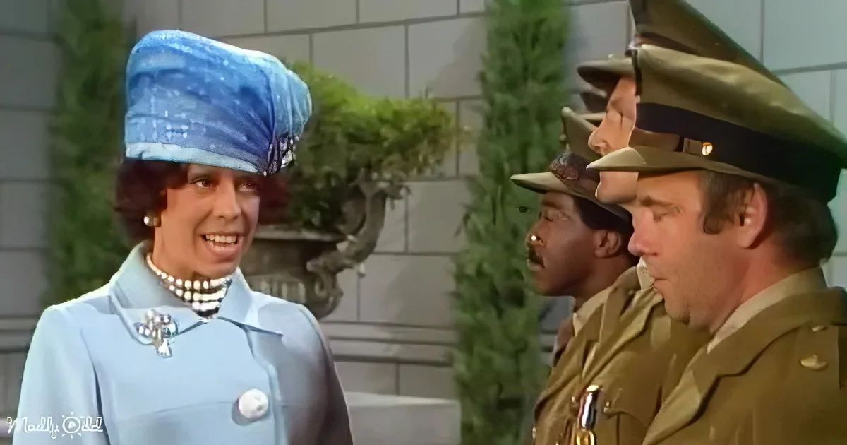 A woman in a blue coat and hat smiles at a group of men in military uniforms.