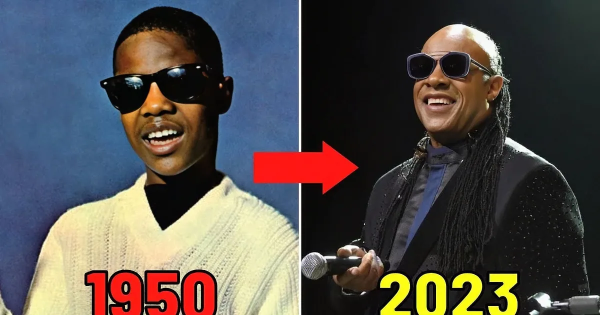 A man wearing sunglasses and a patterned shirt sings into a microphone.