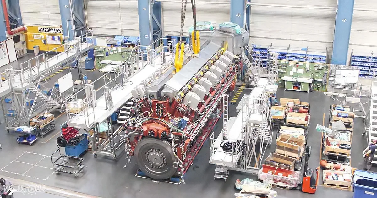 A large industrial machine with multiple components is being assembled or maintained in a factory setting.